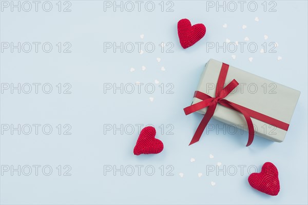 Gift box with red toy hearts table