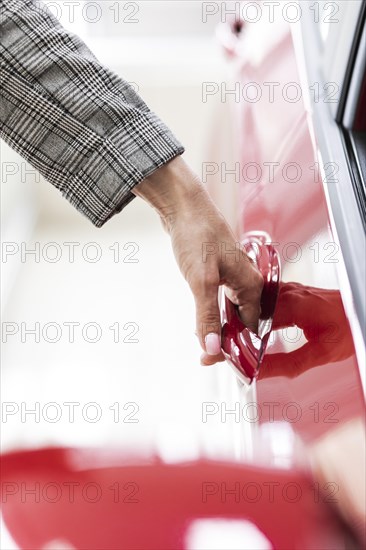 Businesswoman opening car door