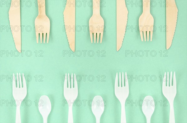 Colorful disposable cutlery turquoise background