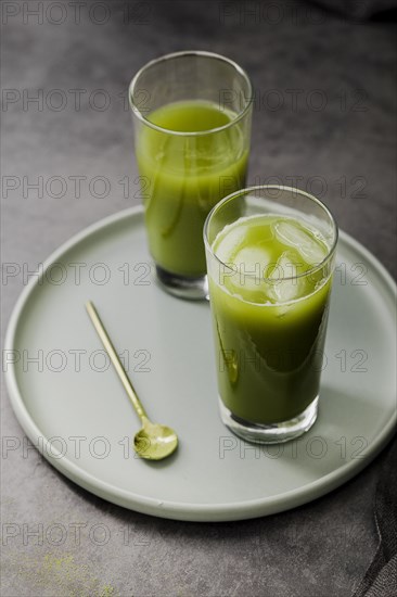 High angle matcha tea glasses with ice cubes