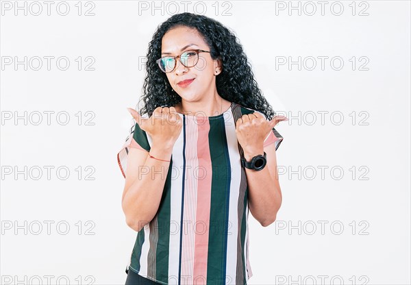 Beautiful afro young woman pointing an offer with both fingers. Smiling afro girl pointing both sides on isolated background. Cheerful girl recommending with fingers