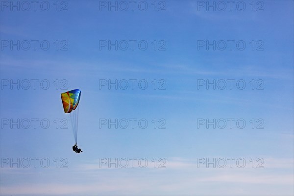 Tandem paragliding high in the sky