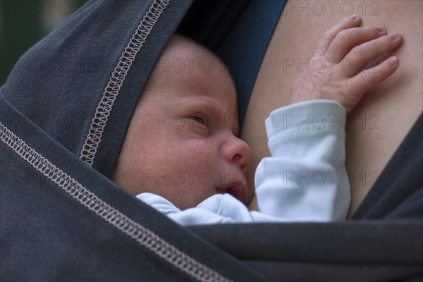 Infant in sling with mother