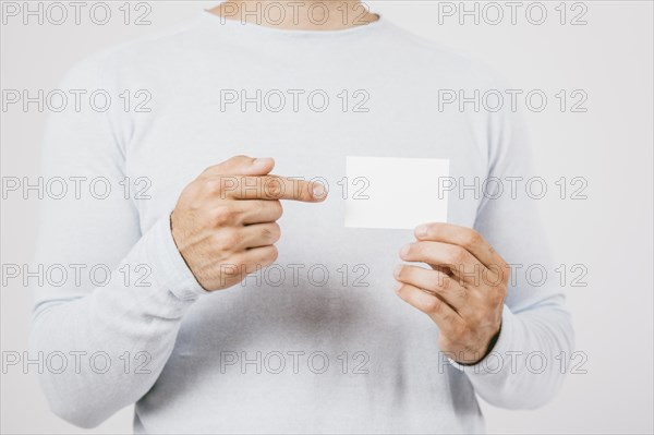 Hand holding business card pointing finger