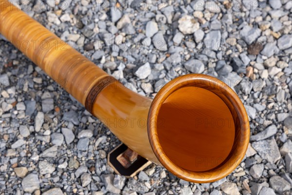 Music Instrument Alphorn Lying on the Ground in a Sunny Day in Switzerland