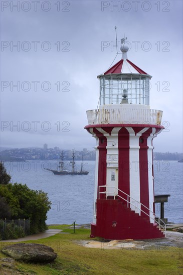 Lighthouse in the harbour with the three-master Bounty