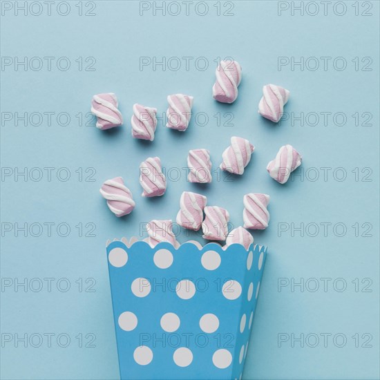 Artistic marshmallows blue table