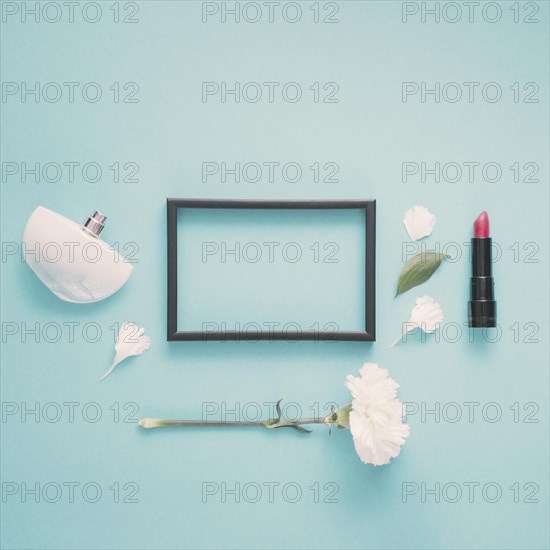 Blank frame with lipstick flower table