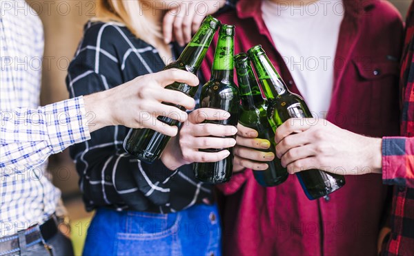 Group friends clinking bottles beer
