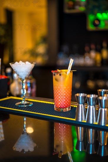 Vertical photo of two glasses of luxury cocktails ready on a counter