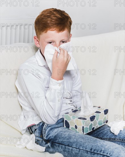 Medium shot child blowing his nose