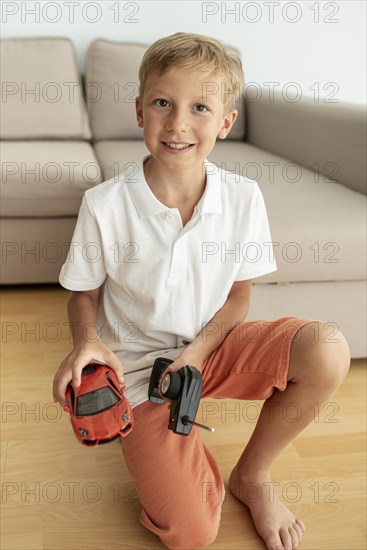 Front view kid playing with electric car