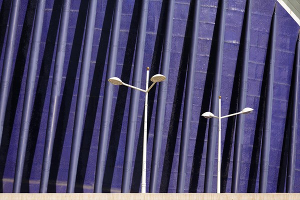 Streetlights in front of a blue facade