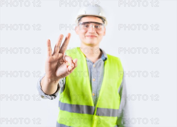 Young engineer counting number three isolated. Male engineer showing number three with fingers isolated