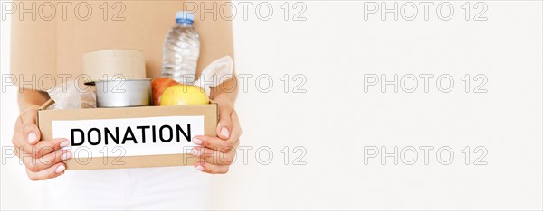 Front view person holding box food donation