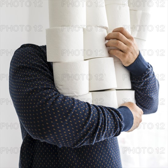 Close up male with stack toilet paper