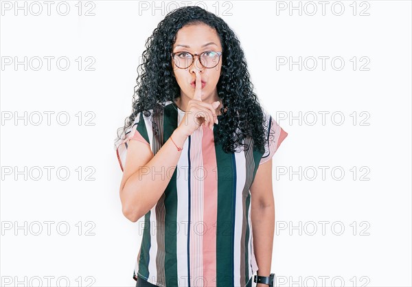 Young woman shushing you with her finger. Afro woman making silence gesture isolated