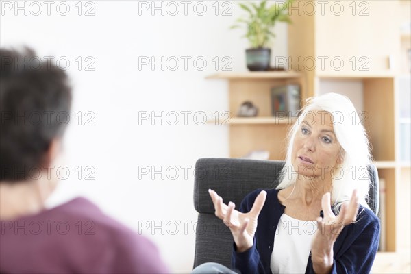 Therapist talking to a patient in a practice