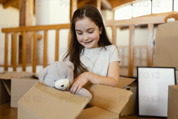 Medium shot girl with toy