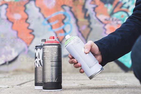 Close up man s hand holding spray bottle