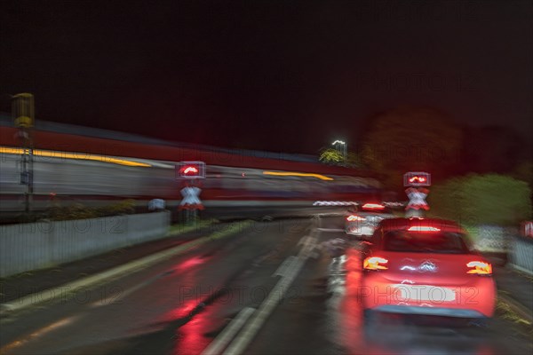 Train crossing a level crossing at night