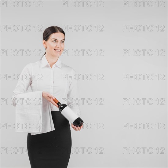 Barkeeper holding bottle wine