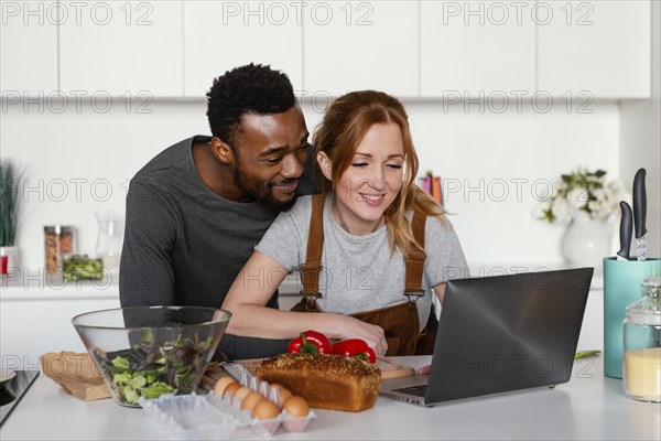 Medium shot couple with laptop