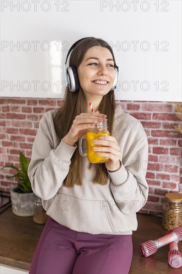 Medium shot smiley woman with drink
