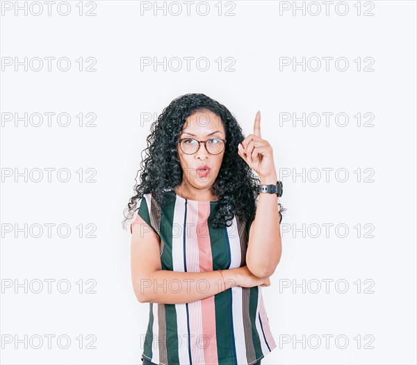 Surprised afro woman pointing up at a promotion isolated. Young woman with afro style hair pointing up