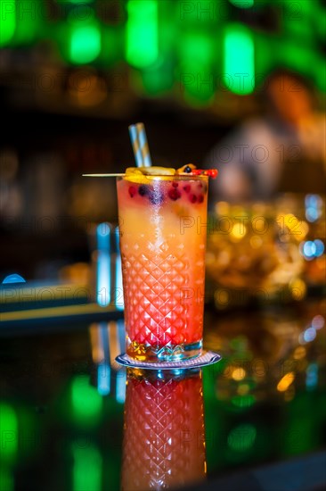 Vertical photo of a Sex on the beach cocktail on the counter of a luxury bar