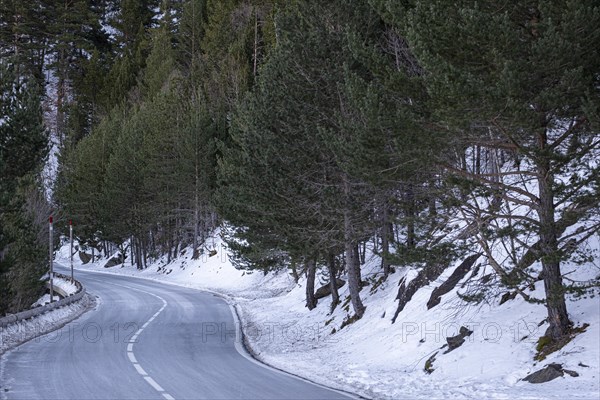 Road in the snowy mountains of the Pyrenees in Andorra during winter