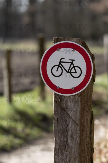 Warning sign no cycling on a country lane in the Duvenstedter Brook nature reserve