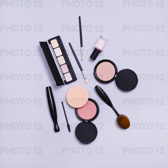 Eyeshadows palette makeup brushes compact face powder purple background