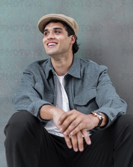 Medium shot smiley man posing with hat