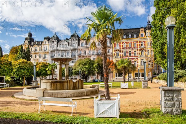 Row of houses with Art Nouveau facades by the autumnal spa park