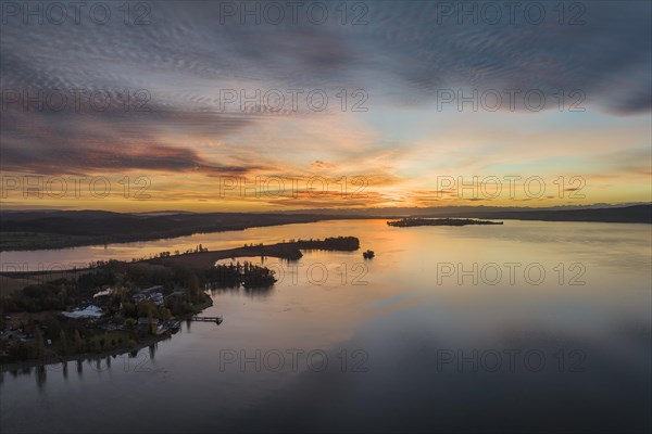 Aerial panorama of western Lake Constance in front of sunrise with the Mettnau peninsula and the island of Reichenau on the horizon