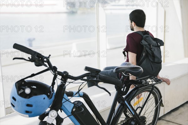 Close up electric bicycle with sitting man background