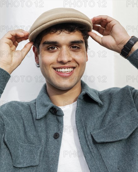 Close up smiley man posing with hat