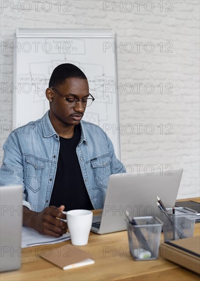 Medium shot business man working laptop