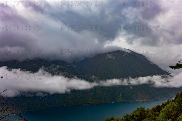 Aerial View over Lake Lugano in Valley with Mountainscape with Storm Clouds in Lugano