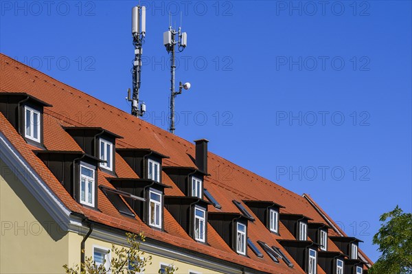 Rores tiled roof with dormers and antennas