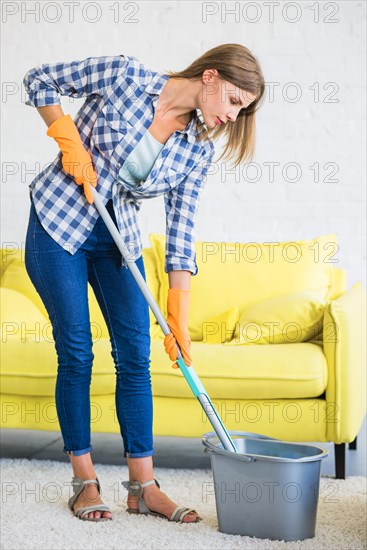 Side view janitor putting mop bucket