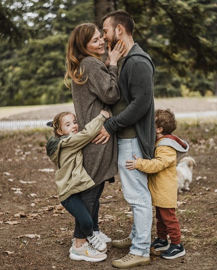 Full shot happy family hugging