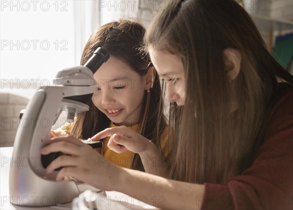 Girl learning with microscope close up