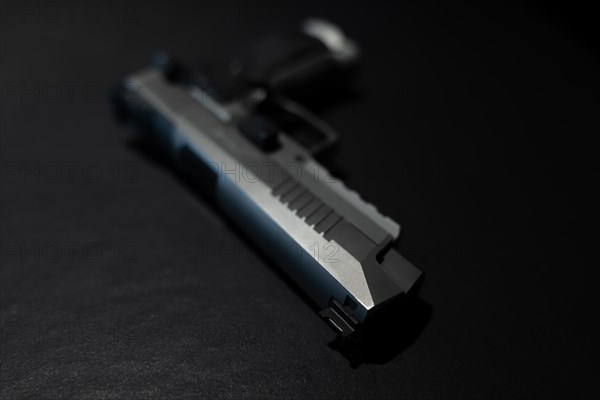 Elegant Chrome Handgun on Gray Granite Background in Switzerland