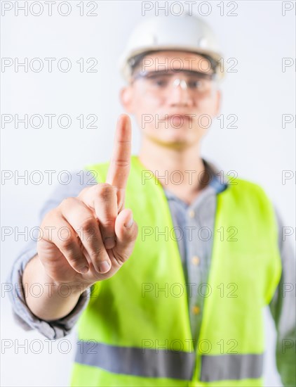 Young engineer counting number one isolated. Male engineer showing number one isolated