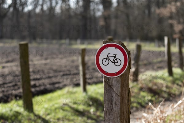 Warning sign no cycling on a country lane in the Duvenstedter Brook nature reserve