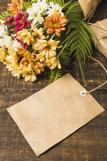Close up blank tag near fresh flowers bouquet