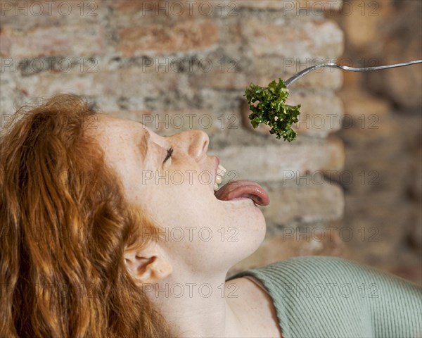 Close up woman eating vegetable