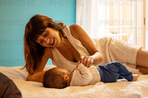 Mother and son lying on the bed in an hotel room